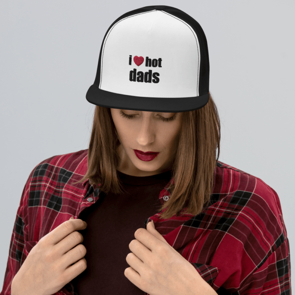 woman in i heart hot dads trucker hat with red heart and black text